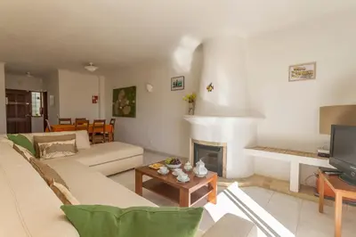 a balcony with a table and chairs and two windows at Casa Tulipa in Luz