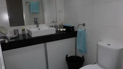 a bathroom with a sink and a toilet at Beach Flat - Apartamento Praia Doca do Cavacas in Funchal
