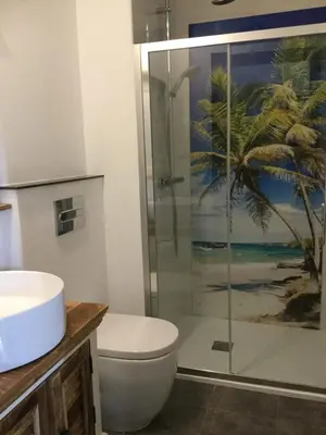 a bathroom with a toilet and a glass shower at Guesthouse-TheView in Ribeira Brava