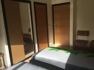 a bedroom with glass doors and a bed in a room at Guesthouse-TheView in Ribeira Brava