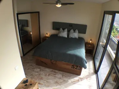 a bedroom with a bed and a large mirror at Guesthouse-TheView in Ribeira Brava