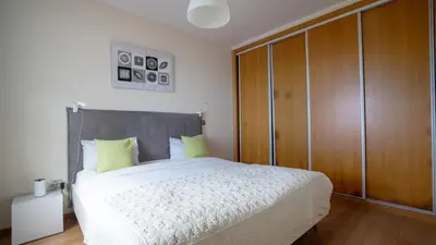 a bedroom with a large bed and a wooden cabinet at Estrela do Mar - by LovelyStay - Lovely, Sun Filled Villa in Calheta