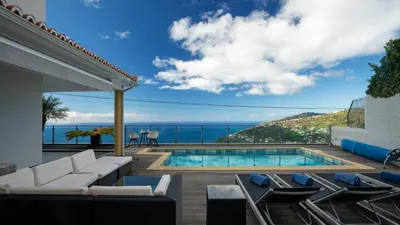 a villa with a swimming pool and a view of the ocean at Estrela do Mar - by LovelyStay - Lovely, Sun Filled Villa in Calheta