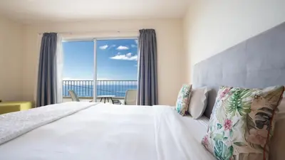 a bedroom with a bed with a view of the ocean at Estrela do Mar - by LovelyStay - Lovely, Sun Filled Villa in Calheta