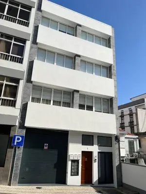a building with a parking garage in front of it at Funchal Downtown Flats 2 in Funchal