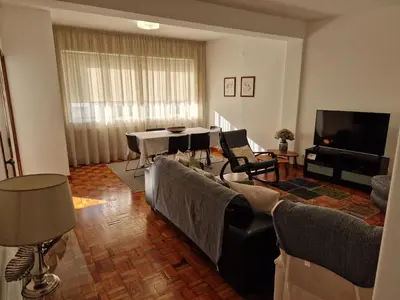 a living room with couches and a table and a television at Funchal Downtown Flats 2 in Funchal