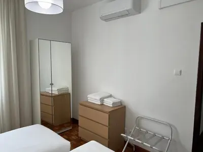 a bedroom with two beds and a mirror and a dresser at Funchal Downtown Flats 2 in Funchal