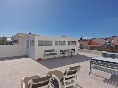 a patio with chairs and a table on a roof at Funchal Downtown Flats 2 in Funchal