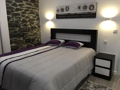 a bedroom with a bed with two pillows on it at Villa Por do Sol in Estreito da Calheta
