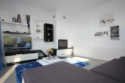 a bedroom with a large bed with two purple pillows at Villa Por do Sol in Estreito da Calheta