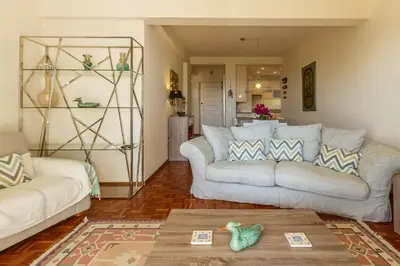 a living room with two couches and a table at CHIQUITA PLACE, Praia da Luz in Luz