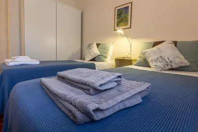 two beds with towels on top of them in a room at CHIQUITA PLACE, Praia da Luz in Luz