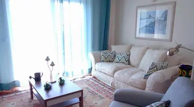 a living room with a couch and a table at CHIQUITA PLACE, Praia da Luz in Luz