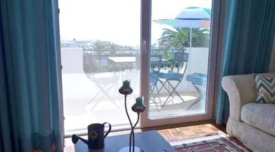 a living room with a view of a patio at CHIQUITA PLACE, Praia da Luz in Luz