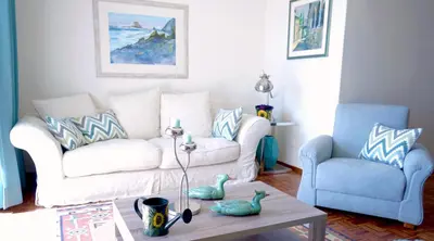 a living room with a white couch and a table at CHIQUITA PLACE, Praia da Luz in Luz