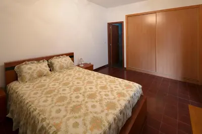 a bedroom with a bed and a large closet at Lobos Rustic House II in Câmara de Lobos