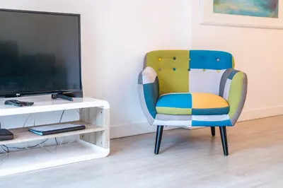a colorful chair sitting in front of a tv at Central Sea View by Amazing Madeira in Funchal