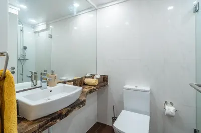 a white bathroom with a sink and a toilet at Central Sea View by Amazing Madeira in Funchal