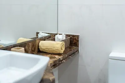 a bathroom with a counter with towels and a sink at Central Sea View by Amazing Madeira in Funchal