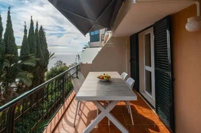 a balcony with a table with fruit on it at Central Sea View by Amazing Madeira in Funchal