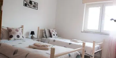 a bedroom with two beds and a window at Beach&Surf Flat in Aljezur