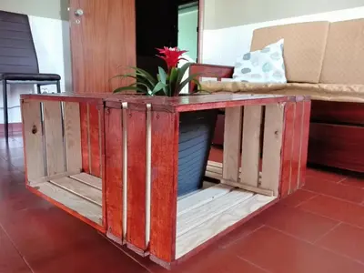 a table made from salvaged wood with a plant on top at Beach&Surf Flat in Aljezur