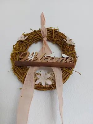 a wreath with a wooden sign on top of it at Beach&Surf Flat in Aljezur