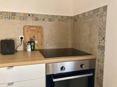 a kitchen with a stove and a counter top at Casa Lusco Fusco in Carrapateira