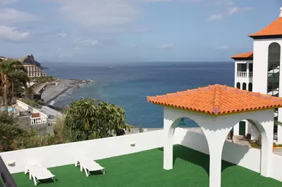 a view of the ocean from the balcony of a house at Canico Bay Apartments in Caniço