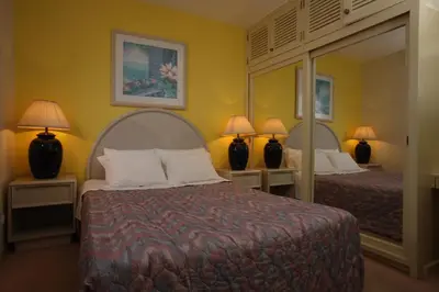 a hotel room with two beds and a mirror at Canico Bay Apartments in Caniço
