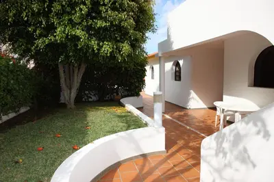 an external view of a house with a garden at Canico Bay Apartments in Caniço
