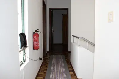 a hallway with a fire extinguisher on the wall at A Slice of Paradise - Palheiro Golf in Funchal