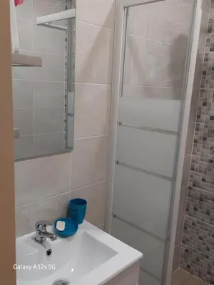 a bathroom with a white sink and a shower at A Slice of Paradise - Palheiro Golf in Funchal