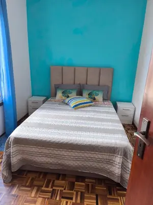 a bedroom with a bed with a blue wall at A Slice of Paradise - Palheiro Golf in Funchal