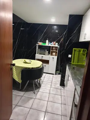 a kitchen with a table and a yellow table and a counter at A Slice of Paradise - Palheiro Golf in Funchal