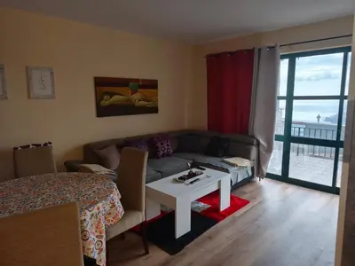 a living room with a couch and a table at A Slice of Paradise - Palheiro Golf in Funchal