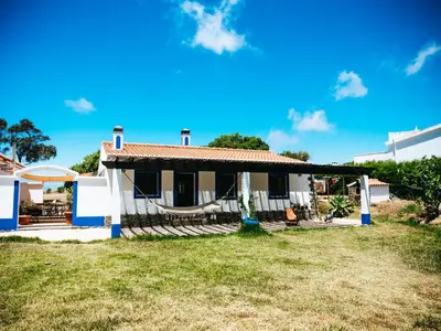 a house with a hammock in front of it at Soul Farm Algarve - Glamping & Farm Houses in Aljezur