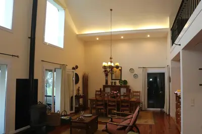 a living room with a table and a dining room at Luxury VILLA CAMÉLIA. Mountains, golf, horses, levada walks. in Santo da Serra
