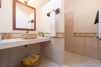 a bathroom with a sink and a mirror and a shower at Luxury VILLA CAMÉLIA. Mountains, golf, horses, levada walks. in Santo da Serra