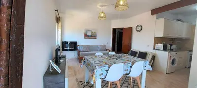 a kitchen and a dining room with a table and chairs at Sunset View Flat in Aljezur