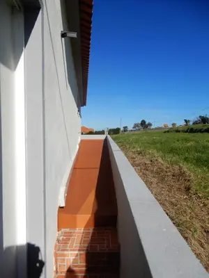 a side view of a wall with a brick path at Jasmine Guest Suite in Ponta do Pargo