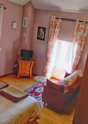 a living room with a couch and a window at Jasmine Guest Suite in Ponta do Pargo