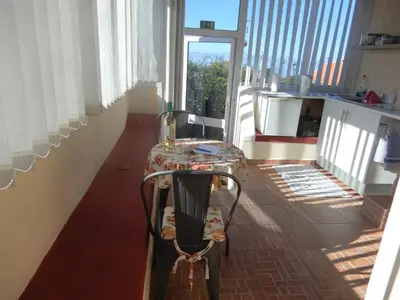 a table on a balcony with a glass top at Jasmine Guest Suite in Ponta do Pargo