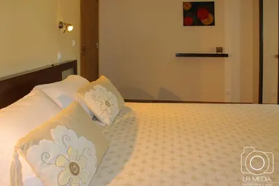 a bedroom with a bed with two pillows on it at Solar do Carvalho in São Vicente