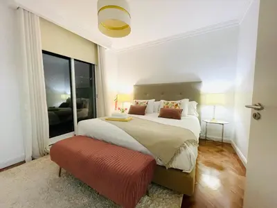 a bedroom with a large bed with a red bench at Susy’s Garden in Funchal