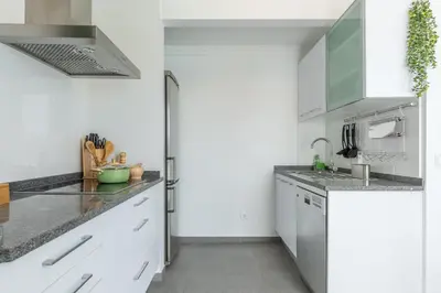 a white kitchen with a sink and a refrigerator at Susy’s Garden in Funchal