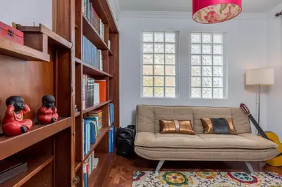 a living room with a couch and bookshelves at Susy’s Garden in Funchal