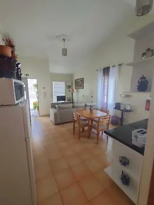 a kitchen and living room with a couch and a table at Costa Residence Funchal View in Funchal