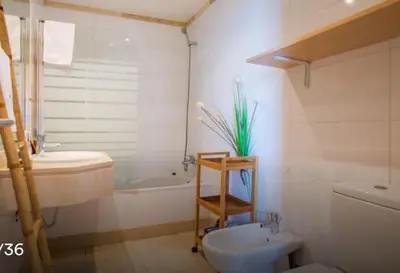 a bathroom with a toilet and a sink and a tub at TRIPLEX TERRASSE VUE EXCLUSIVE SUR L OCÉAN ,WIFI in Santa Cruz