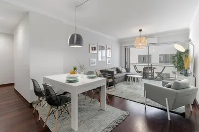 a living room with a white table and chairs at Santa Catarina II by An Island Apart in Funchal